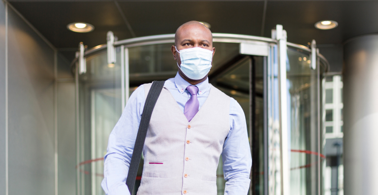 Man with facemask exiting building