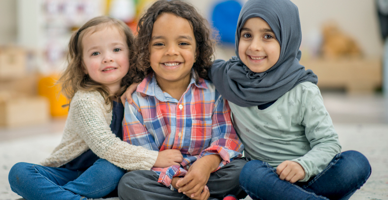 3 children sitting and smiling