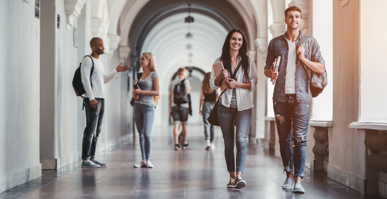  Students walking through campus hallway