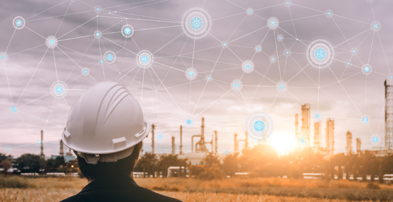 Person wearing hardhat looking at power plant