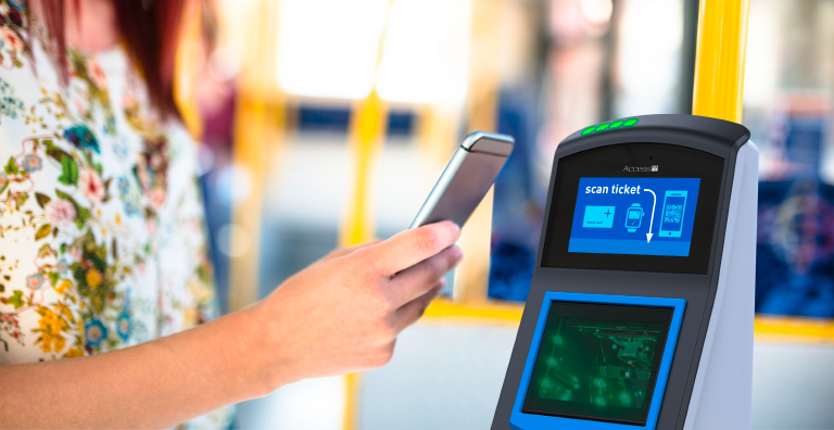 A person holding a phone to scan a ticket via contactless payment.