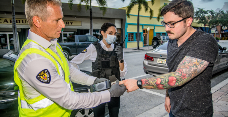 A police officer using biometric identification