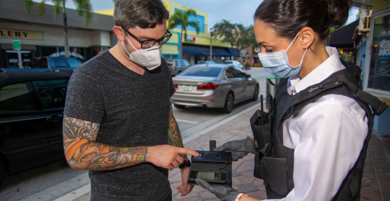 A police officer using biometric identification