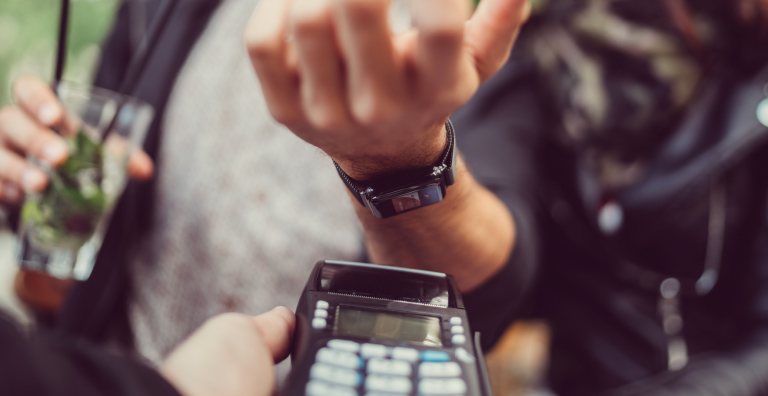 person using smart watch to pay bill