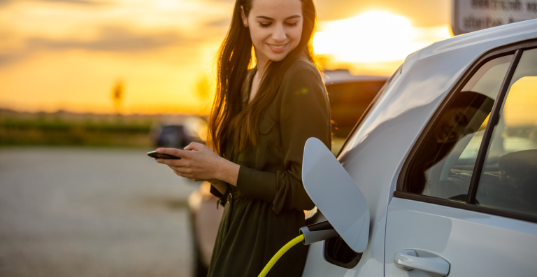 person charging electric vehicle