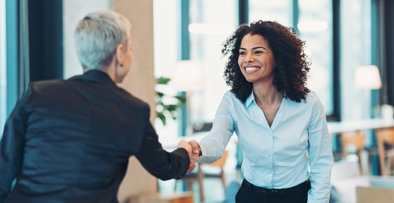 people shaking hands in office