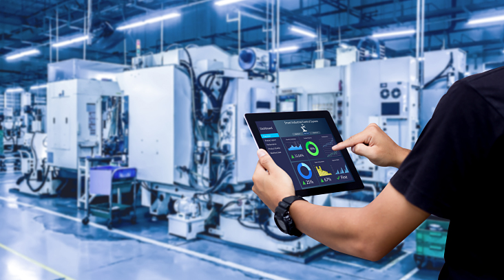 person holding tablet in factory