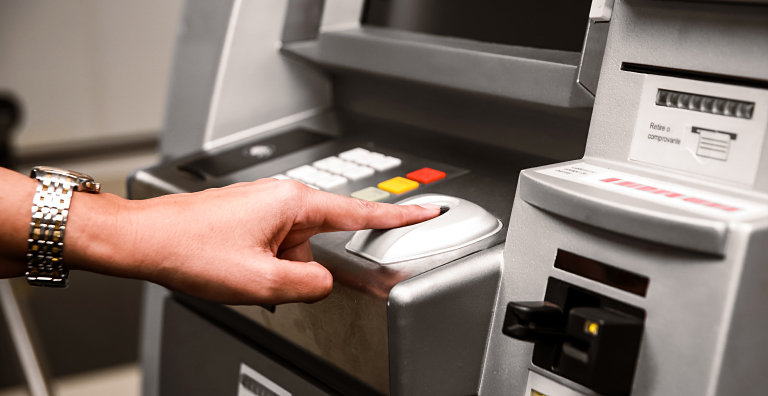 person scanning finger at ATM