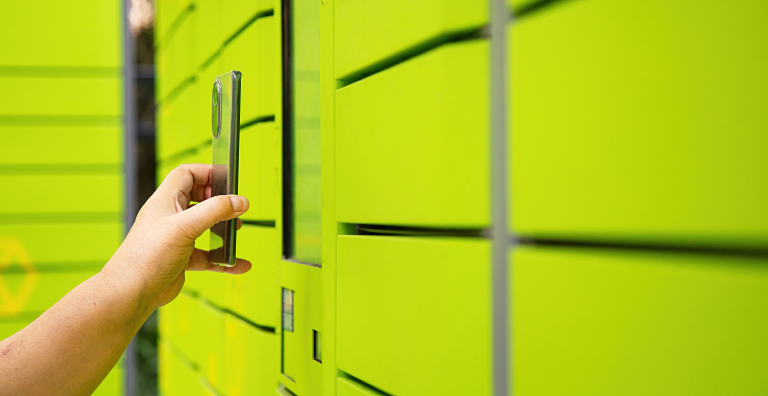 person holding phone up to smart locker