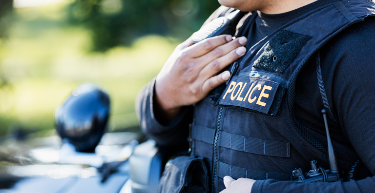 police officer speaking into walkie talkie