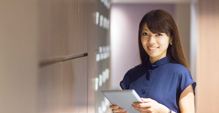 person holding tablet in front of smart lockers