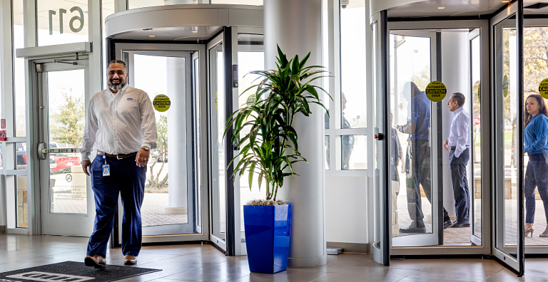 people entering building through revolving door